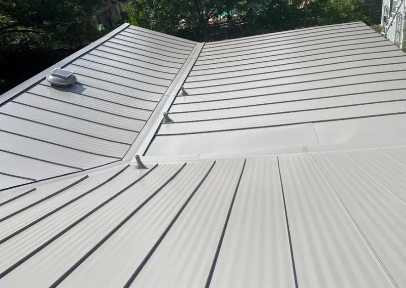Solar attic fan installed on a metal roof for Roof Ventilation in Country Homes